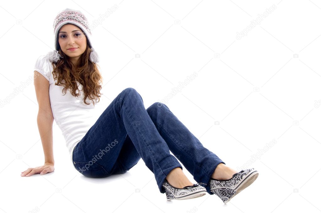 Fashionable girl wearing cap on floor Stock Photo by ©imagerymajestic