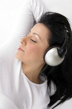 Gorgeous young female tuned in music clipart