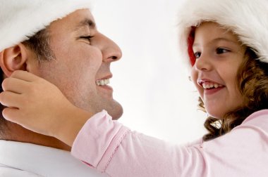 Girl pulling father's ears clipart