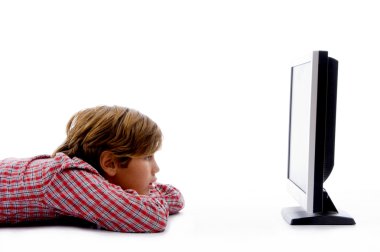 Side pose of boy watching lcd tv clipart