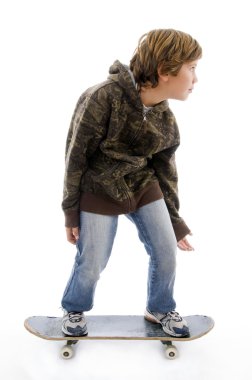 Young child standing on skateboard clipart