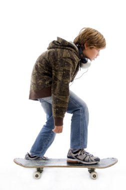 Little boy riding skateboard clipart