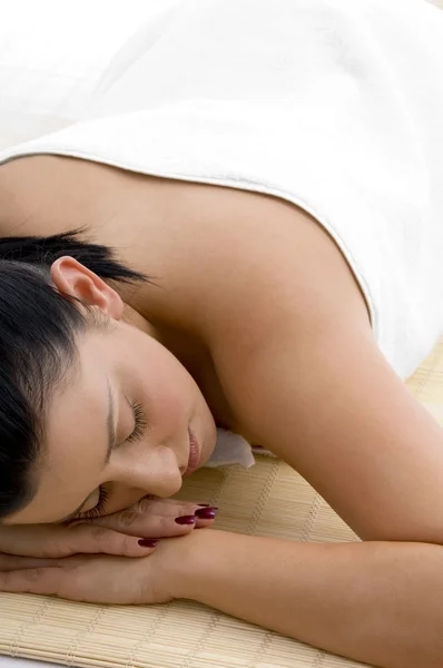 Young woman sleeping on mat, in towel — Stock Photo, Image