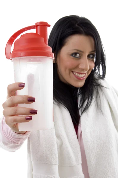 Smiling young woman showing water bottle — Stock Photo, Image