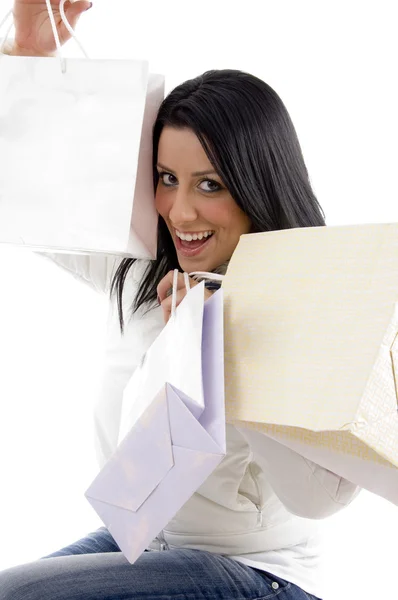 Cheerful female model with carry bags — Stock Photo, Image