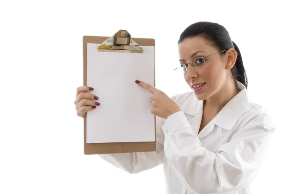 Female doctor pointing at writing pad — Stock Photo, Image