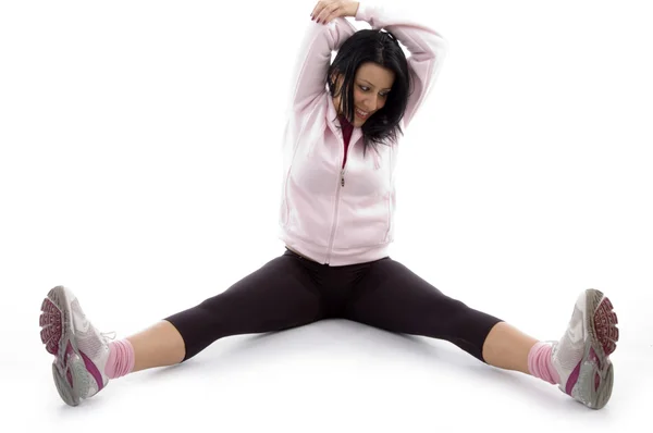 Woman doing exercise, stretching legs — Stock Photo, Image