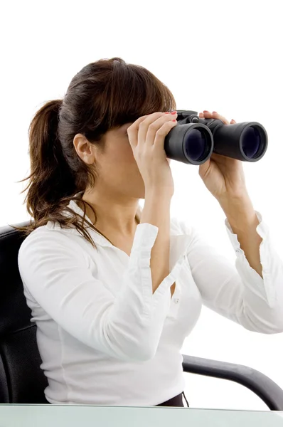Young female looking through binoculars — Stock Photo, Image