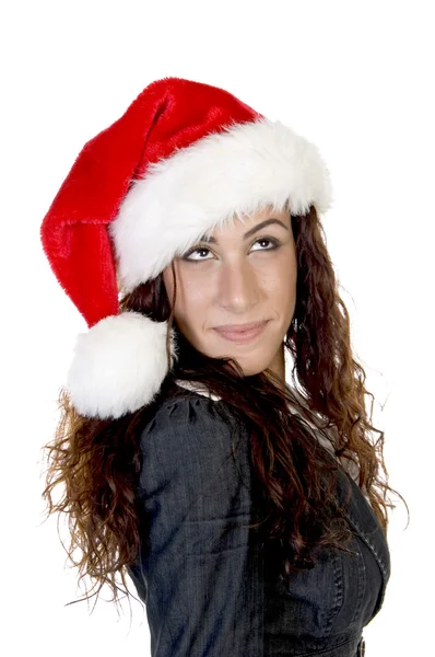Žena v vánoční klobouk dívá se nahoru — Stock fotografie