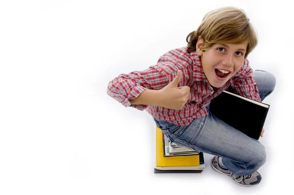 Top view of boy sitting on pile of books — Stock Photo, Image