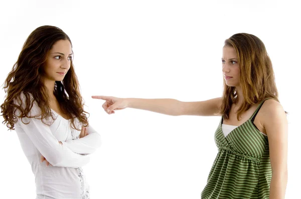 Chica joven señalando a su amigo —  Fotos de Stock