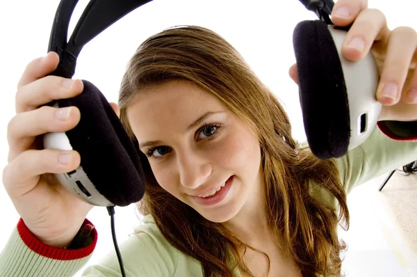 Woman showing headphones — Stock Photo, Image