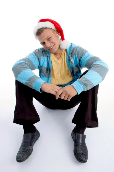 Sitting male with christmas hat — Stock Photo, Image