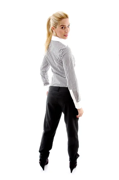 Back pose of female looking at camera — Stock Photo, Image