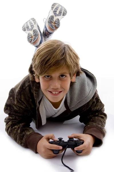 微笑着的小男孩在玩视频游戏 图库图片
