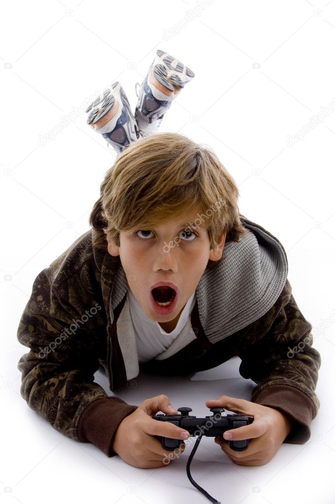 Front view of surprised kid playing videogame on an isolated white background