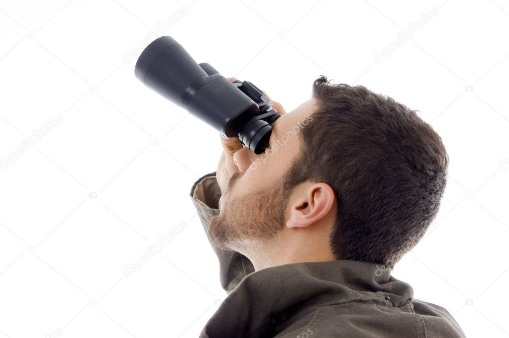 Hispanic man looking through binoculars