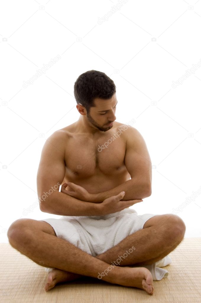 Shirtless young man with crossed legs
