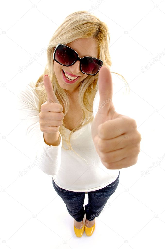 Cheerful young woman with thumbs up