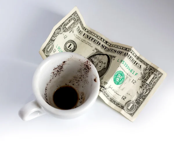 Empty cup of coffee and dollar — Stock Photo, Image