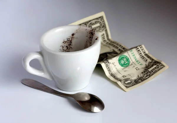 Empty cup of coffee and dollars — Stock Photo, Image
