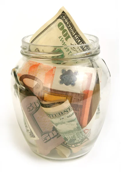 Dollar and euro bills in glass jar — Stock Photo, Image