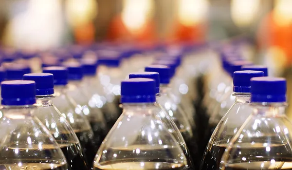 Plastic flessen op transporter — Stockfoto