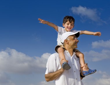 Child on man shoulders clipart