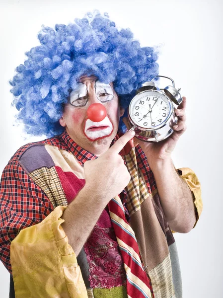 Unhappy clown with alam clock — Stock Photo, Image