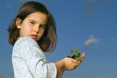 Girl holding plant clipart