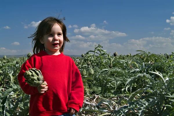 Young girl holding artichok — Stock Photo, Image