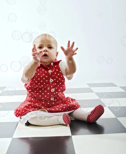 Baby girl and soap bubbles — Stock Photo, Image