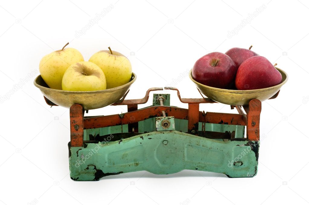 Old scales with yellow and red apples