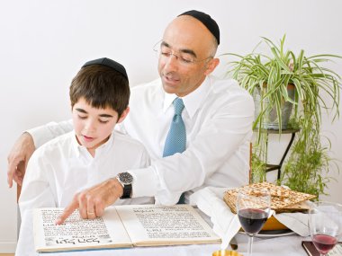 Father and son celebrating passover clipart