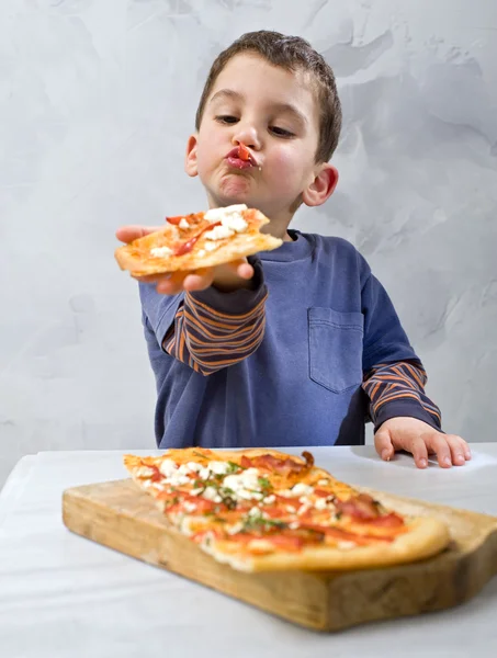 Pizza yiyen genç çocuk. — Stok fotoğraf