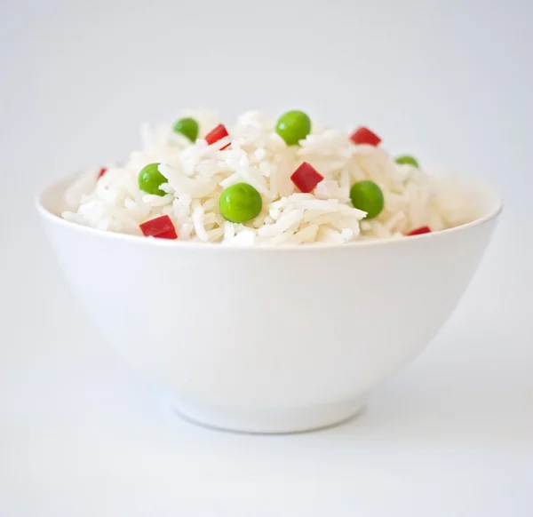 Bowl of rice with peas an peppres — Stock Photo, Image