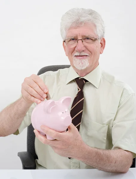 Senior man and piggybank — Stock Photo, Image