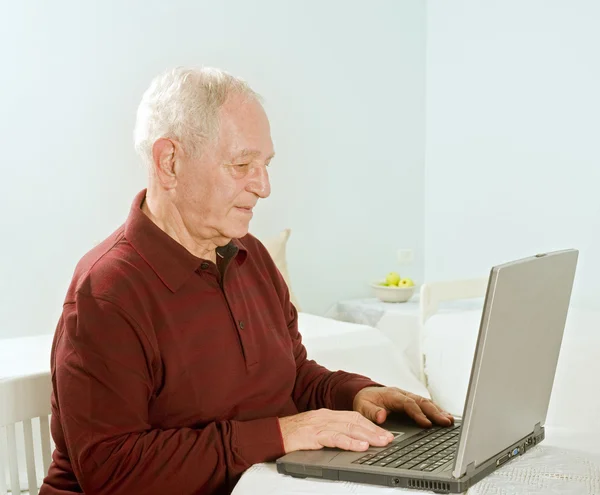 Homem sênior com computador portátil — Fotografia de Stock
