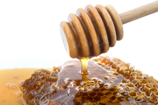 Honey dripper and honeyconb — Stock Photo, Image
