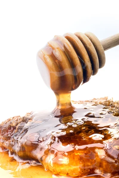 Honey dripper and honeyconb — Stock Photo, Image