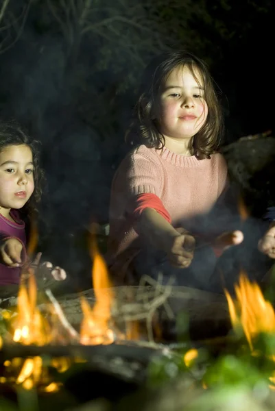 Two girls at a bonfire — Stock Photo, Image