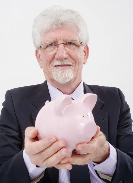 Senior businessman and piggybank — Stock Photo, Image