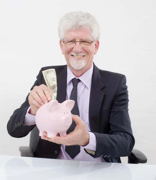 Senior businessman and piggybank — Stock Photo, Image