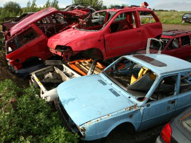 Car cementary with many broken cars clipart