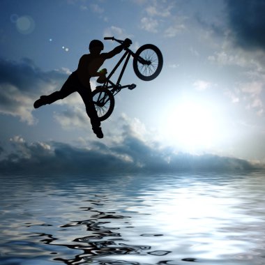 Silhouette of boy with bicycle jumping clipart