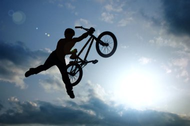 Silhouette of boy with bicycle clipart