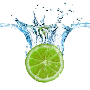 Fresh lime dropped into water clipart