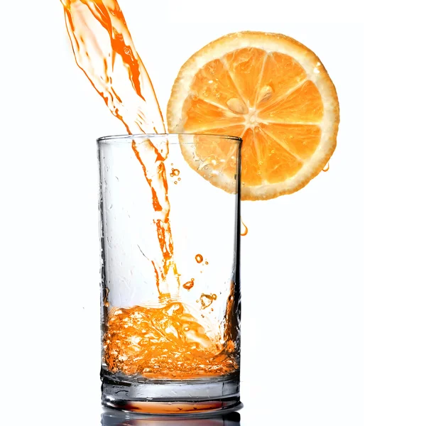 Sumo de laranja derramando em cálice — Fotografia de Stock