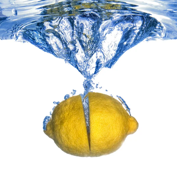 Fresh lemon dropped into water — Stock Photo, Image