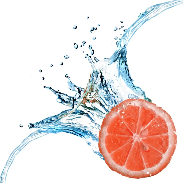 Fresh grapefruit dropped into water — Stock Photo, Image